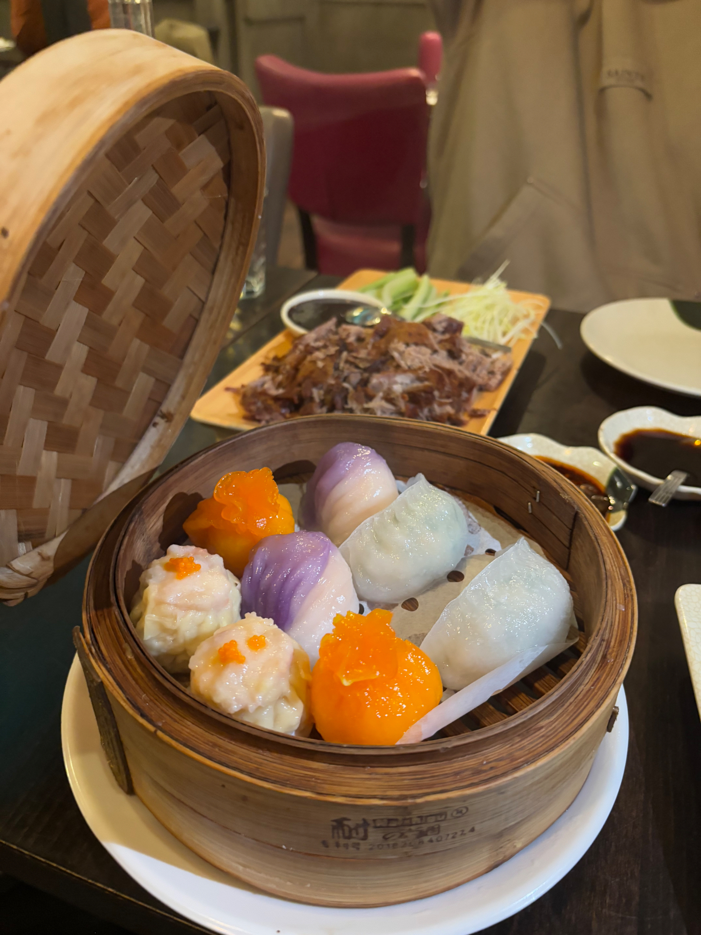 Mixed dim sum dumplings in a bamboo steamer